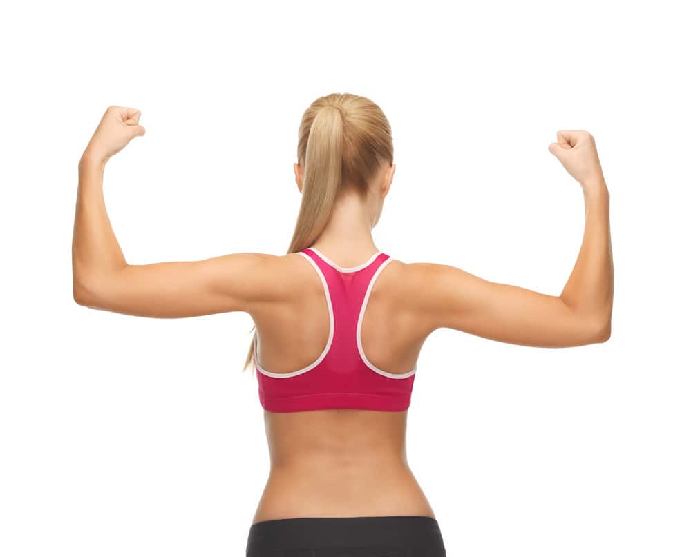 picture of woman from behins with her arms up flexing muscles