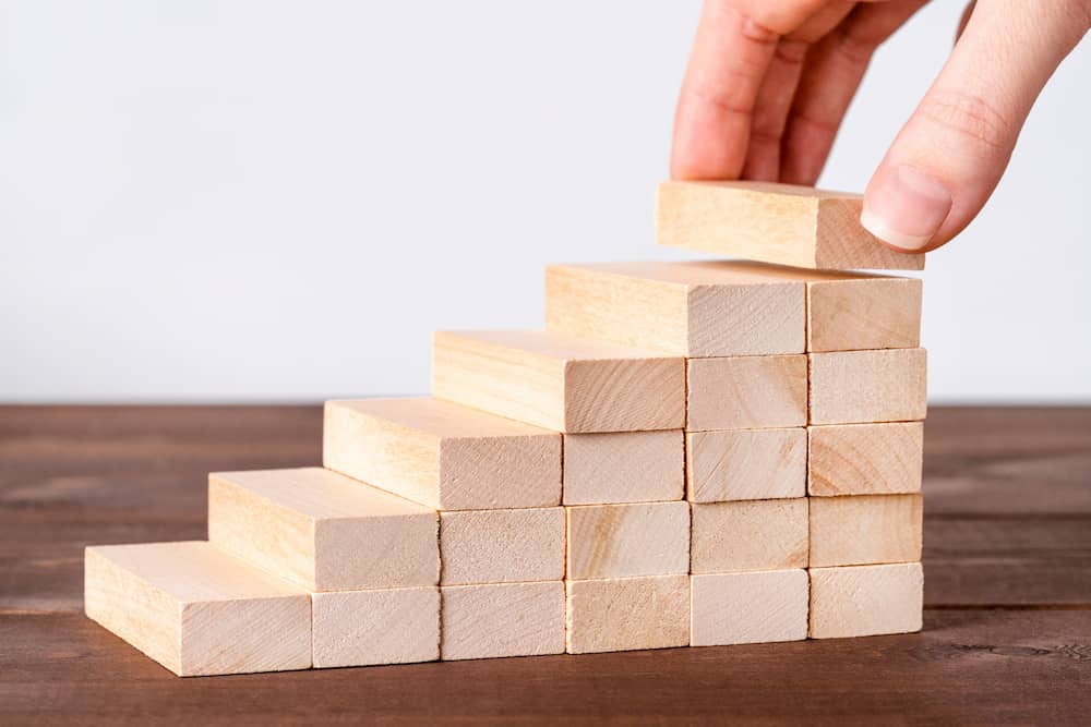 A stack of jenga blocks in the shape of steps.